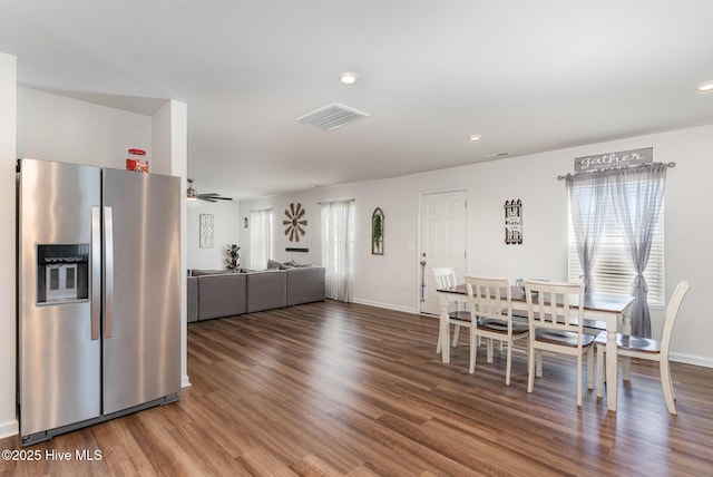 dining room with baseboards, wood finished floors, visible vents, and recessed lighting