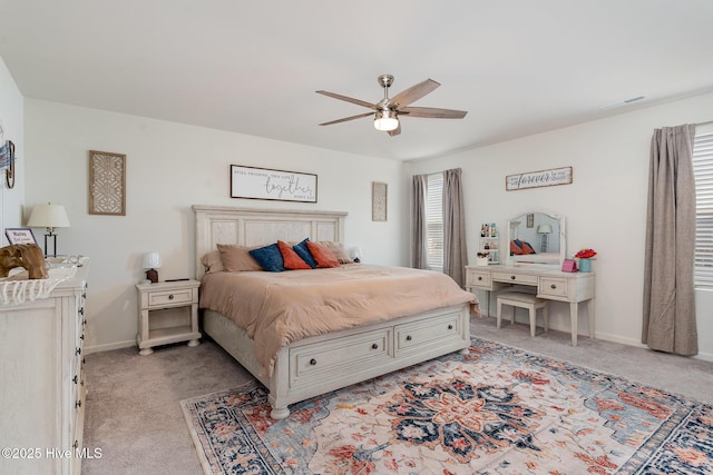 bedroom with baseboards, ceiling fan, visible vents, and light colored carpet