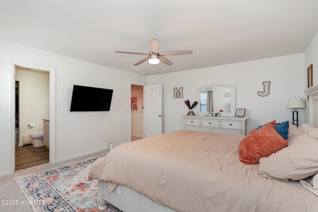 bedroom with light carpet, a ceiling fan, baseboards, and connected bathroom