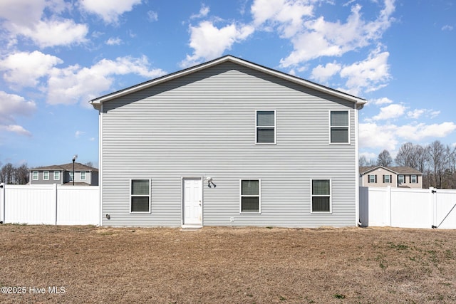 rear view of property with fence