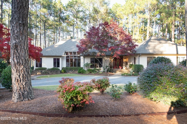 view of front of property with a chimney and stucco siding