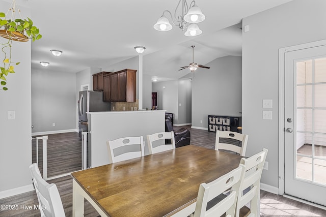 dining space featuring lofted ceiling, ceiling fan, baseboards, and wood finished floors