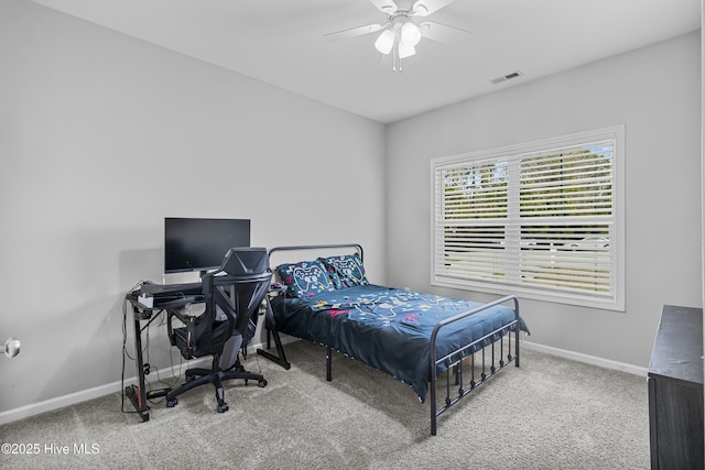 carpeted bedroom with baseboards, visible vents, and ceiling fan