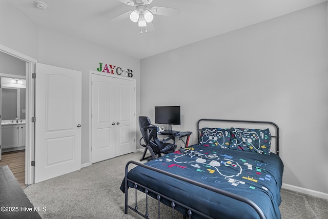 carpeted bedroom with a closet, baseboards, and a ceiling fan