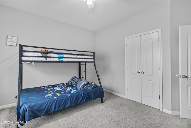 bedroom featuring carpet, baseboards, and a closet