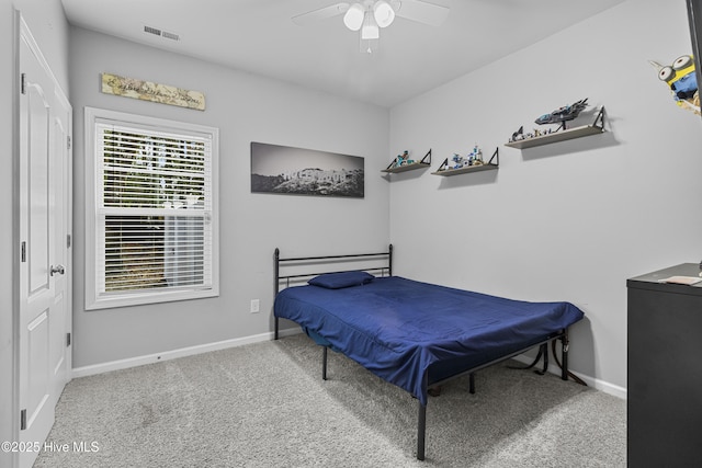 carpeted bedroom with visible vents, ceiling fan, and baseboards