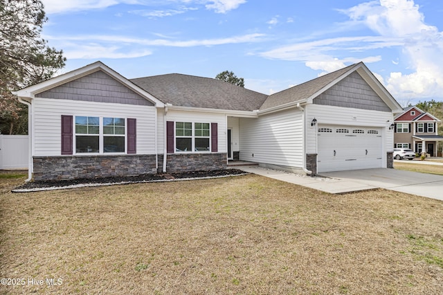 view of front of house with roof with shingles, an attached garage, stone siding, driveway, and a front lawn