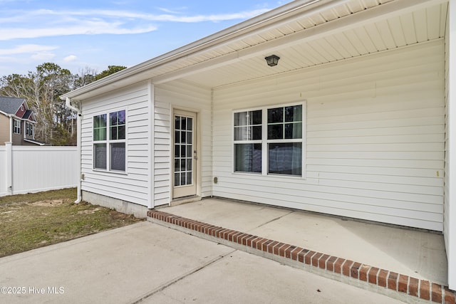 property entrance featuring a patio area and fence