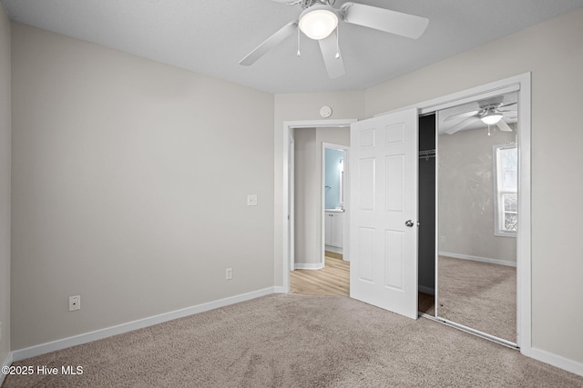 unfurnished bedroom featuring carpet, baseboards, and a closet