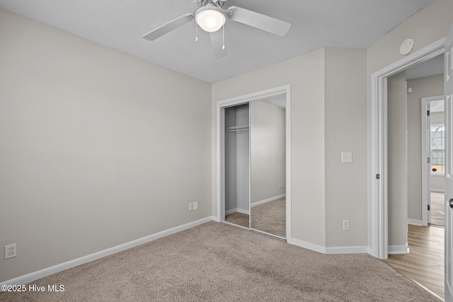 unfurnished bedroom with a ceiling fan, carpet, baseboards, and a closet