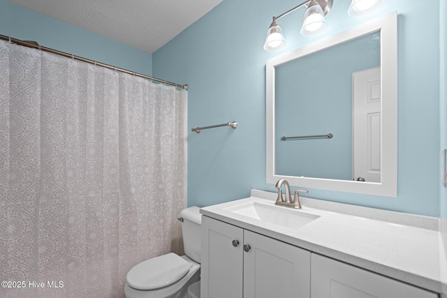 bathroom with toilet, a shower with curtain, a textured ceiling, and vanity