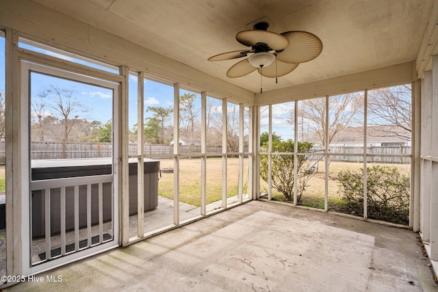 unfurnished sunroom featuring a ceiling fan