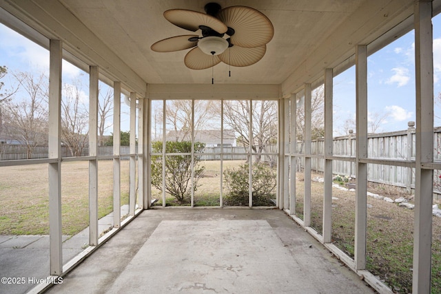 unfurnished sunroom featuring a ceiling fan