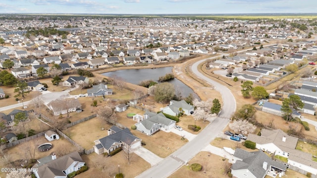 drone / aerial view featuring a water view and a residential view