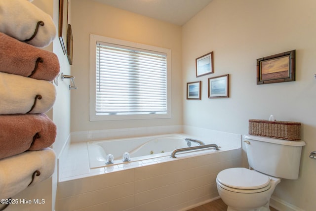 full bath with a whirlpool tub and toilet