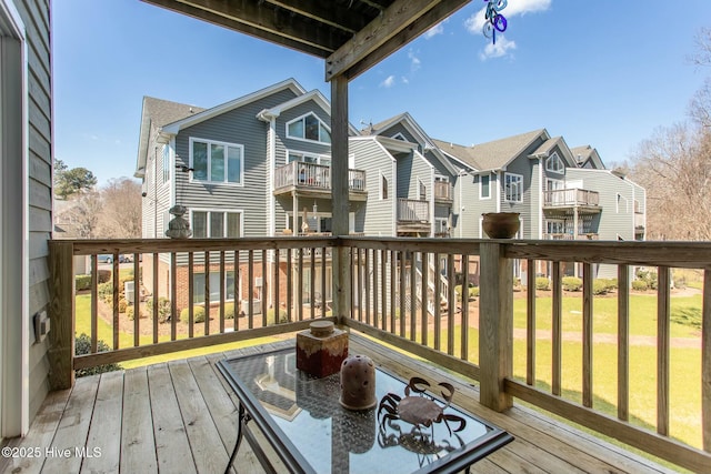 deck featuring a lawn and a residential view