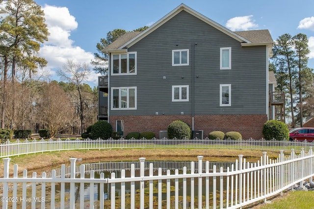 view of home's exterior featuring fence private yard and brick siding