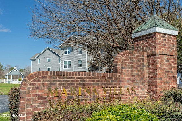 community sign featuring fence