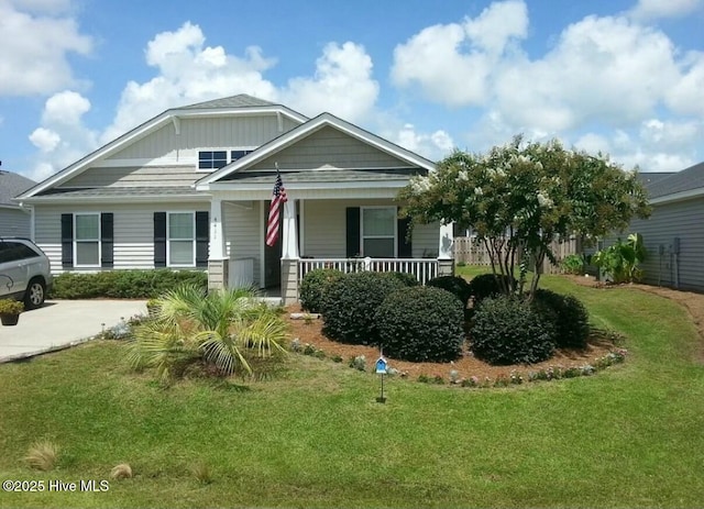 craftsman-style house featuring a front yard and covered porch