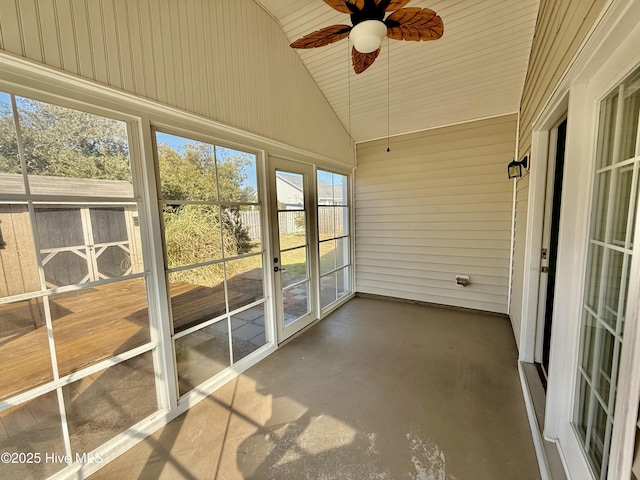 unfurnished sunroom with a ceiling fan and lofted ceiling