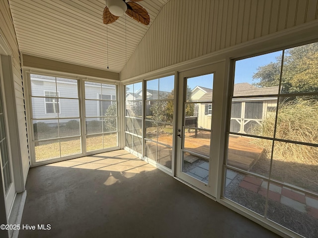 unfurnished sunroom featuring lofted ceiling and ceiling fan