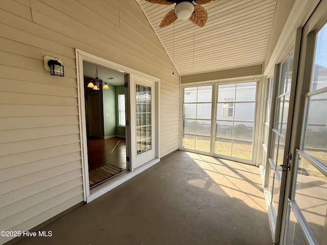 unfurnished sunroom with lofted ceiling and a ceiling fan