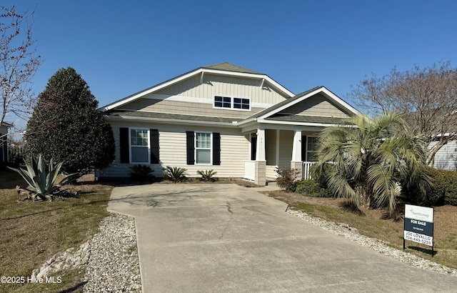 view of front facade featuring board and batten siding and covered porch