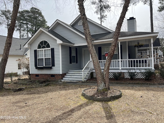 view of front of house featuring crawl space, covered porch, a chimney, and roof with shingles