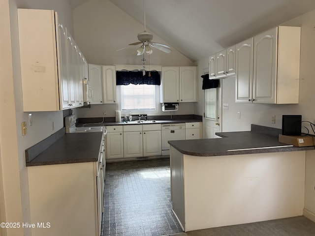 kitchen with ceiling fan, a peninsula, white appliances, white cabinetry, and dark countertops