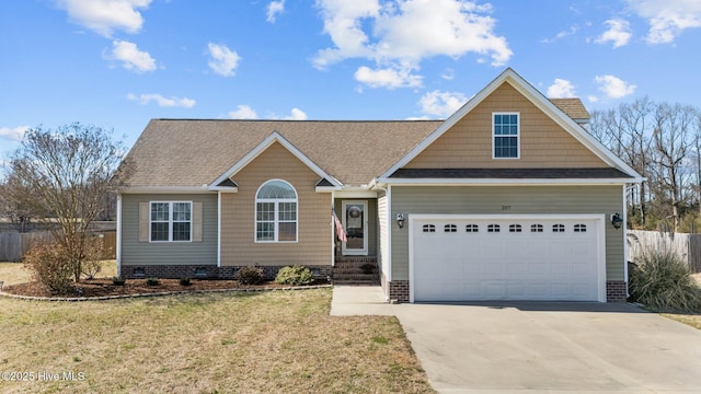 view of front facade with driveway, an attached garage, fence, and a front lawn