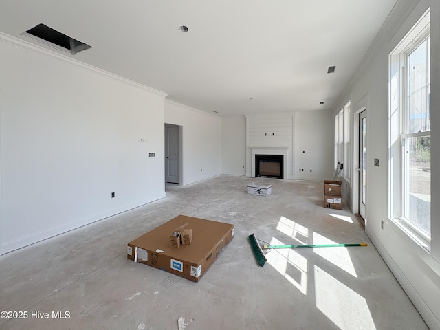 unfurnished living room featuring crown molding, baseboards, and a large fireplace