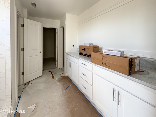 bathroom with unfinished concrete flooring and visible vents