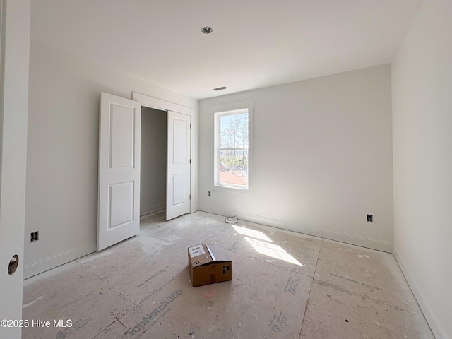 unfurnished bedroom with visible vents and baseboards