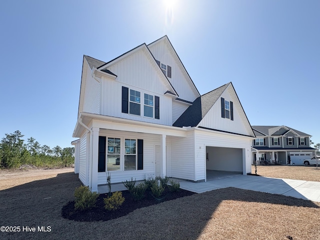 modern inspired farmhouse featuring driveway and a garage