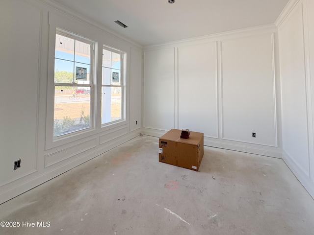 unfurnished room featuring a decorative wall and concrete floors