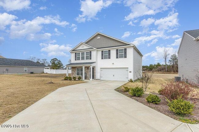 traditional-style house featuring a garage and concrete driveway