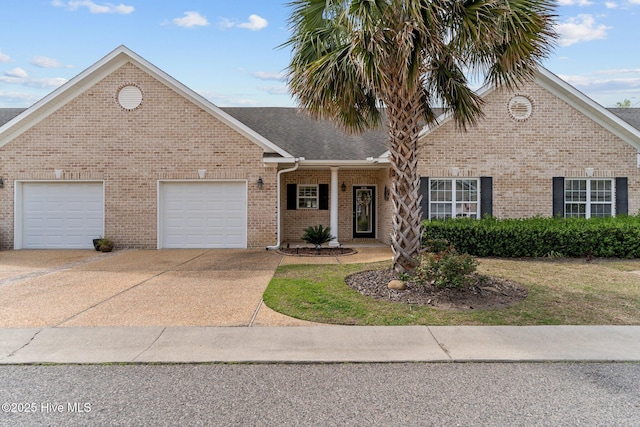 1036 Tideline Dr, Leland, NC 28451 - view of front facade featuring a garage, concrete driveway, brick siding, and a shingled roof
