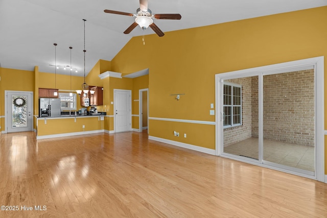 1036 Tideline Dr, Leland, NC 28451 - unfurnished living room with light wood-type flooring, high vaulted ceiling, and a ceiling fan