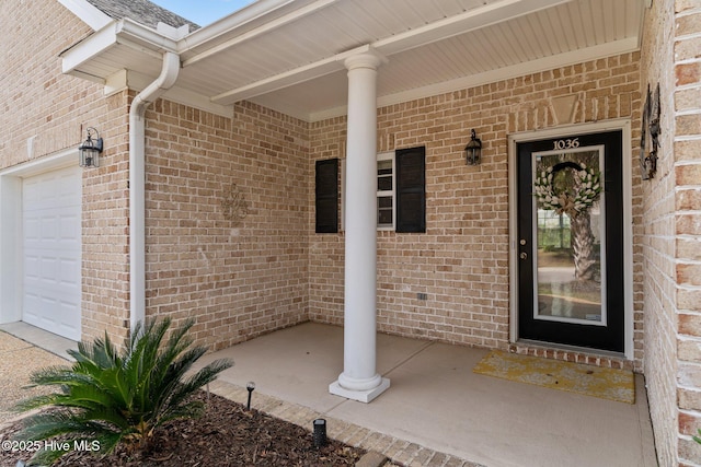 1036 Tideline Dr, Leland, NC 28451 - entrance to property featuring a porch, brick siding, and a garage