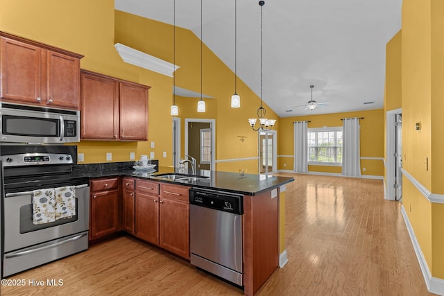 1036 Tideline Dr, Leland, NC 28451 - kitchen with stainless steel appliances, high vaulted ceiling, light wood-style floors, ceiling fan, and open floor plan