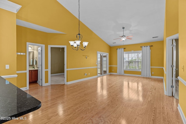 1036 Tideline Dr, Leland, NC 28451 - unfurnished living room featuring high vaulted ceiling, ceiling fan, light wood-style floors, and a chandelier