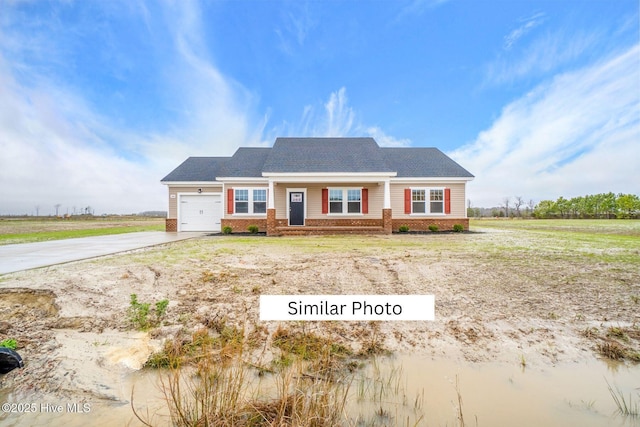 view of front of house featuring concrete driveway, brick siding, and an attached garage