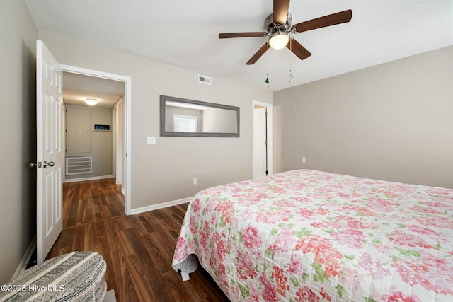 bedroom featuring visible vents, baseboards, a ceiling fan, and dark wood-style flooring