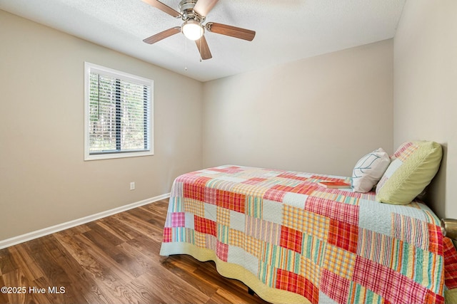 bedroom featuring a ceiling fan, wood finished floors, and baseboards