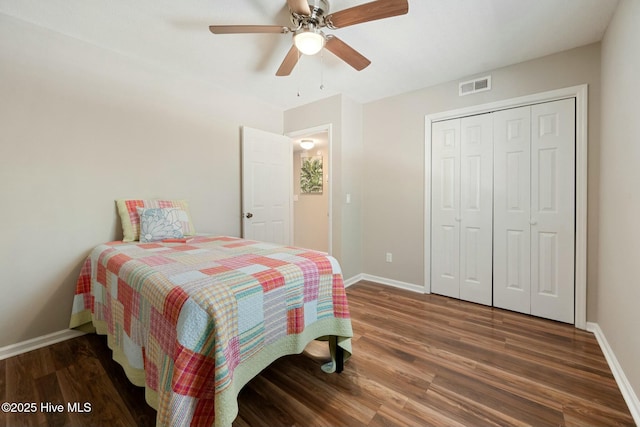 bedroom featuring visible vents, baseboards, a closet, and wood finished floors