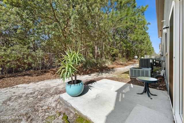 view of patio / terrace featuring cooling unit and fence