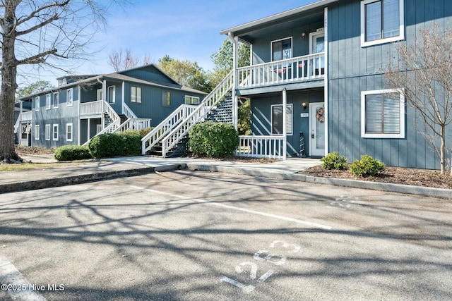 exterior space with stairs and uncovered parking