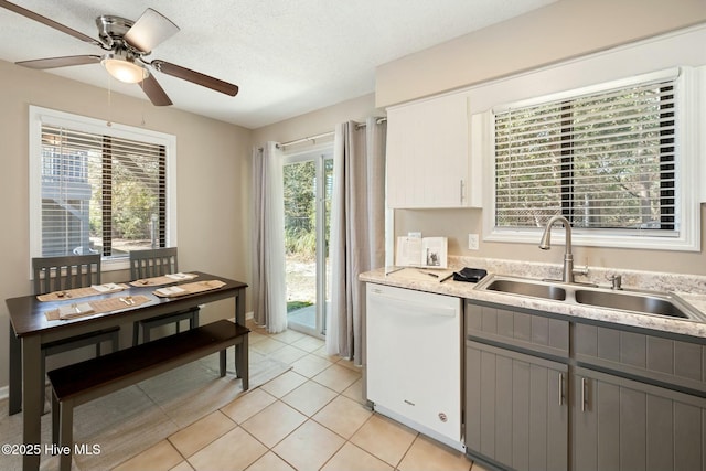 kitchen with a ceiling fan, gray cabinetry, a sink, light countertops, and dishwasher