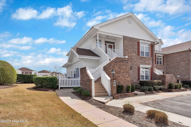 8855 Radcliff Dr NW Unit 4D, Calabash, NC 28467 - view of front of property with stairway, brick siding, and uncovered parking