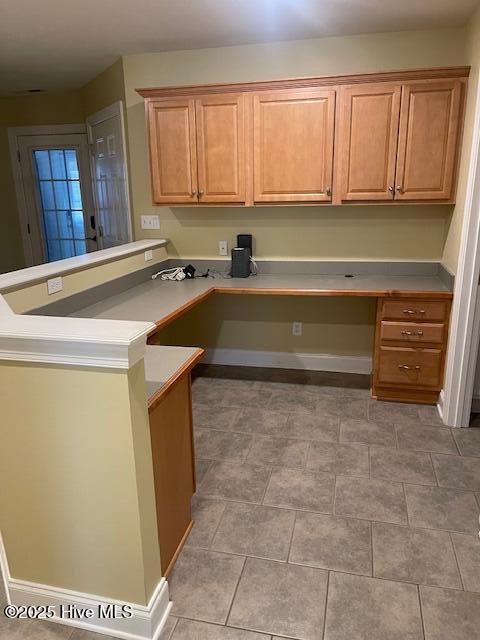 unfurnished office featuring built in study area